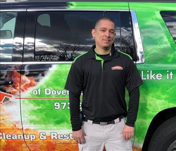 man in work uniform of black shirt with SERVPRO logo 