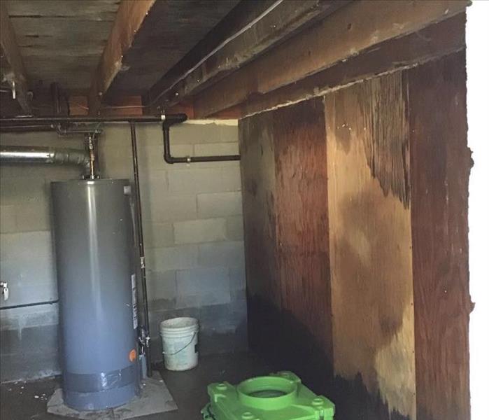 Water damage in a basement with SERVPRO equipment out