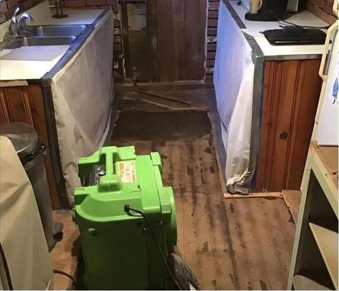 SERVPRO equipment on the floor of a kitchen. 
